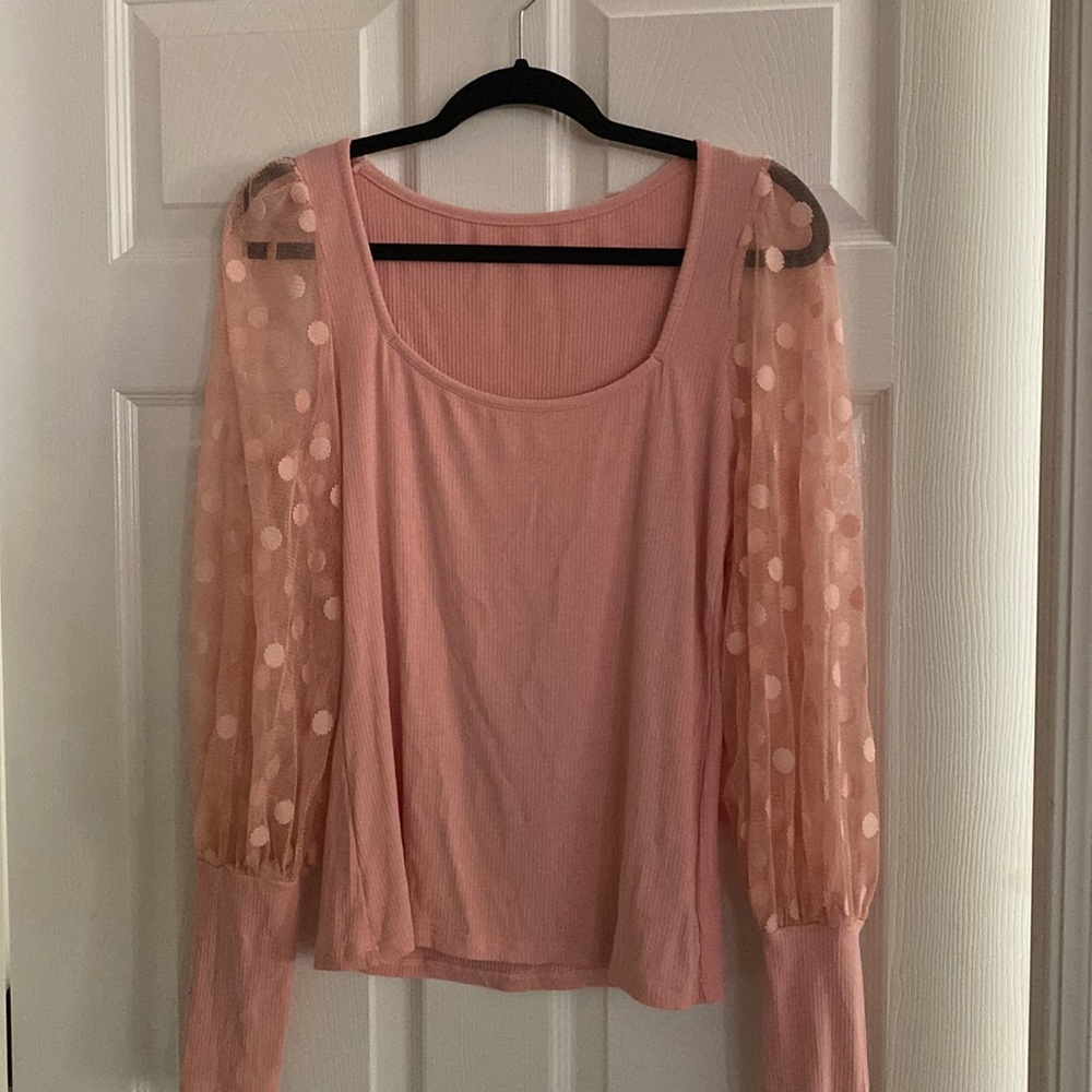 Woman’s large mauve colored top